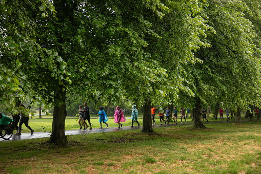 A wide shot of a group of run participants taking part in a fun run in Leazes Park in Newcastle upon Tyne, North East England. They are running along a treelined path in the rain. The race is open to people of all ages and abilities and is also dog friendly.

These files have similar videos/images available.