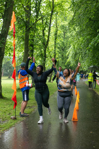 istock Friends Crossing the Finish Line Together 1700064700