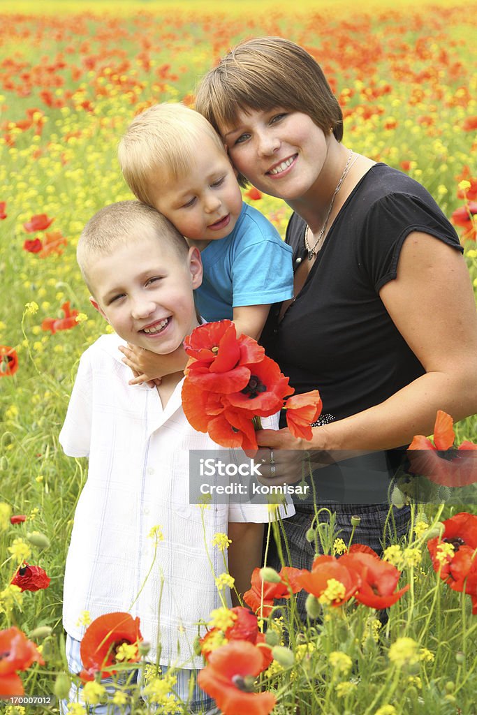 Woman with children Woman with children in the flowering spring field 12-17 Months Stock Photo