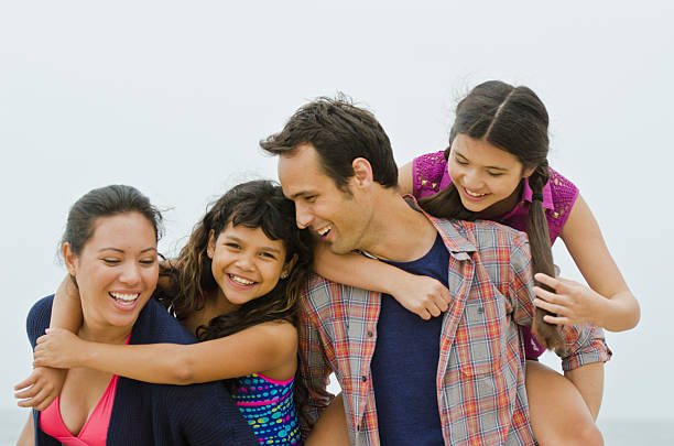 istock Happy parents piggybacking their children 170007027