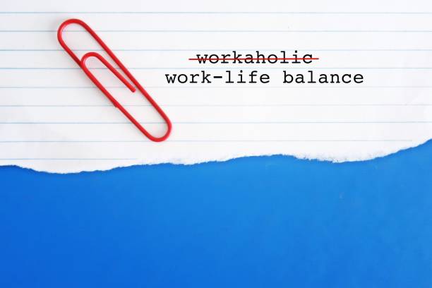 Torn paper on blue copy space background with text WORKAHOLIC, crossed off to WORK LIFE BALANCE, to balance work and life commitments, to avoid burnout, anxiety or negative effects of too much stress