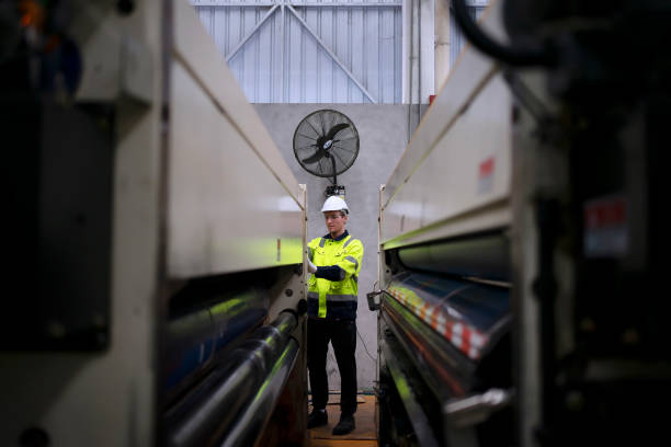 istock Blue collar worker and cardboard package factory. 1700079576
