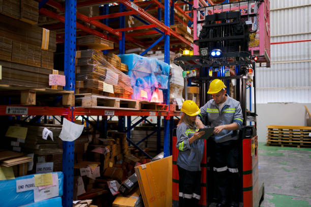 istock Blue collar worker and cardboard package factory. 1700080346