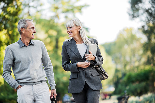 istock Two businesspeople taking a walk in park. 170008646