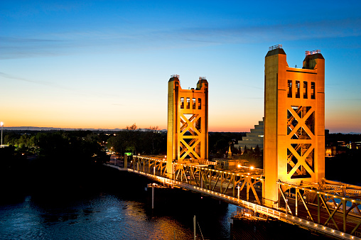 This beautiful Tower Bridge in the Capitol City of Sacramento California, glows at night, with the colorful Sunset it really shows its beautiful color. Very Shallow depth of field.