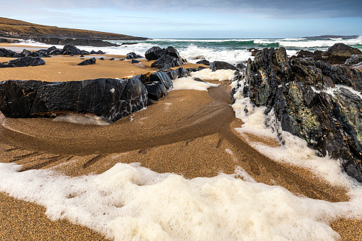 Strong waves creating sea foam on this lovely beach called Traigh Bheag (The Small Beach) just south of Borve on the Isle of Harris, Outer Hebrides, Scotland