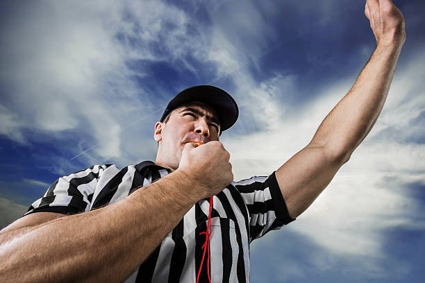 Referee against the clouds. Football referee blowing whistle.    referee stock pictures, royalty-free photos & images