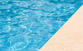 The edge of a hotel pool on a summer day. Empty space. Selective focus on the foreground. summer holiday concept