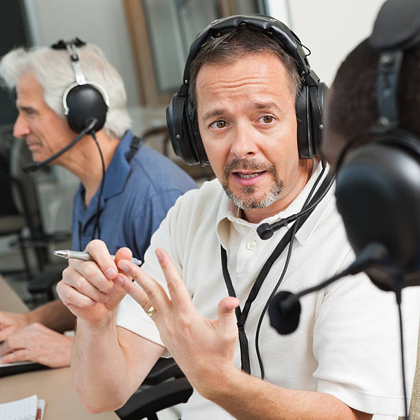 istock Serious Sports Commentator discussing game in the press box 170011680