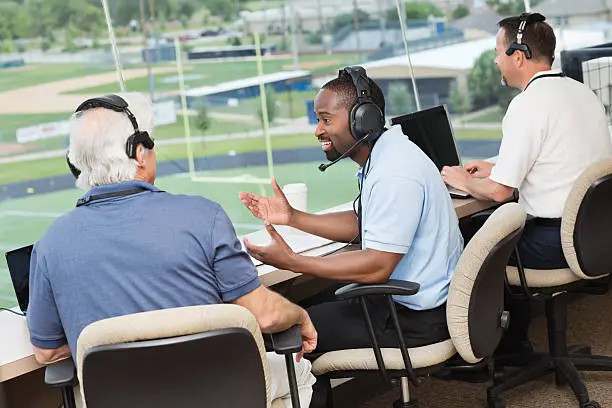 Group of sports reporters and commentators discussing football game