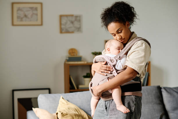 Young mother caring about baby at home