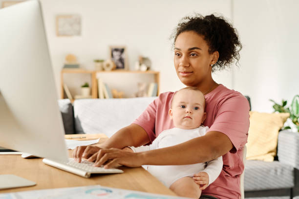 istock Mother working online while sitting with baby at home 1700118815