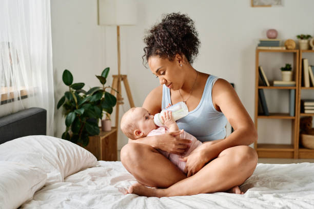 istock Mother feeding her baby from bottle 1700119433