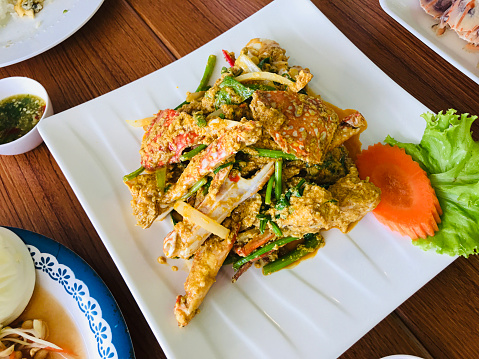 Stir-Fried Crab with yellow curry powder and egg in Phuket, Thailand.