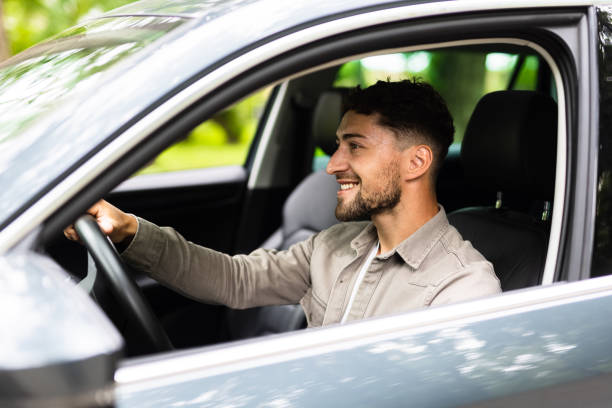 istock Young Man driving his car on way to work. 1700150104