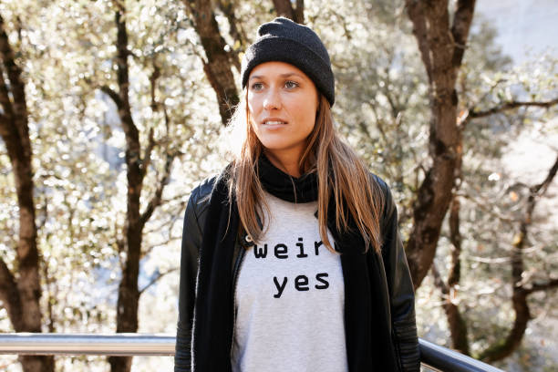 Young beautiful female standing against trees during winter
