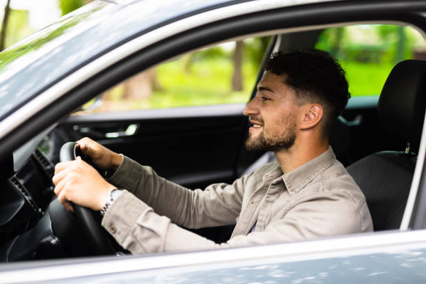 istock Young Man driving his car on way to work. 1700150640