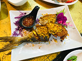 Fried Blacked-banded trevally with garlic in Phuket, Thailand.