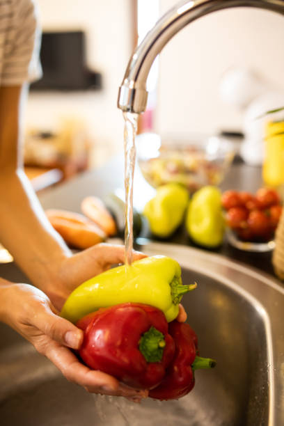 istock Washing red and green peppers 1700154147