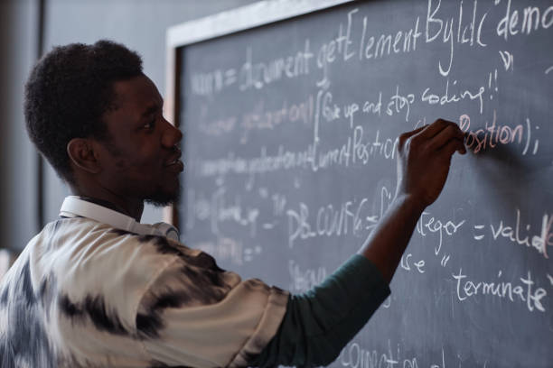 istock Teacher writing on blackboard in the classroom 1700164839