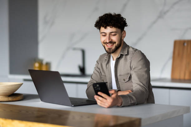 istock Young man use notebook and phone work in the morning 1700172709
