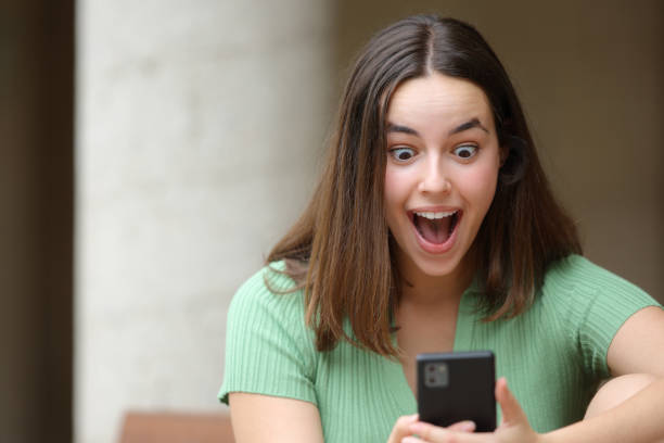 istock Amazed woman checking surprising content on phone 1700197256