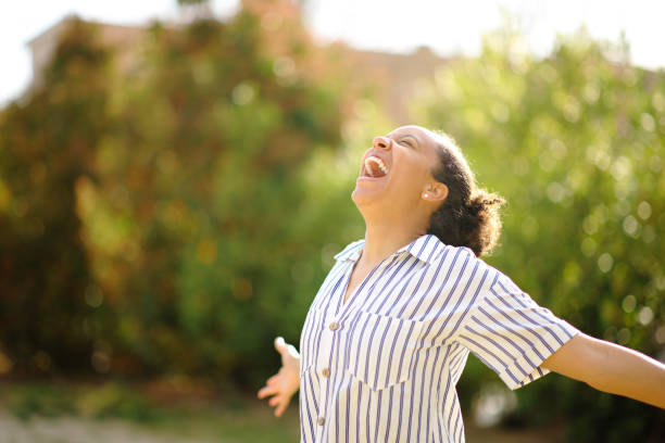 istock Excited black woman screaming in a park 1700198335