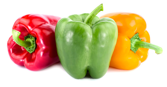 Three colorful bell peppers red yellow and green colors in a row isolated on white background