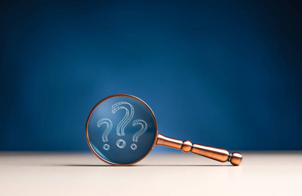 istock Finding or Searching for idea concept, search for information, find out, Find the answer. Close-up magnifier glass with question mark icons on wooden table. Inspire for discovery of new innovation. 1700212459