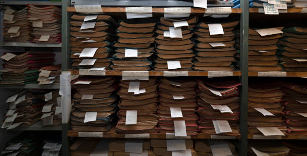 Old files are stacked on an archive shelf