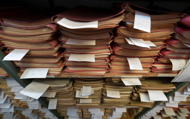 istock Stacks of old papers and files in an archive 1700219773