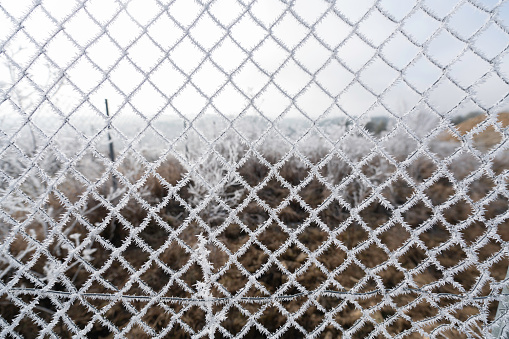 Chainlink fence covered in winter snow