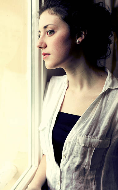istock Teenage looking through window 170022853