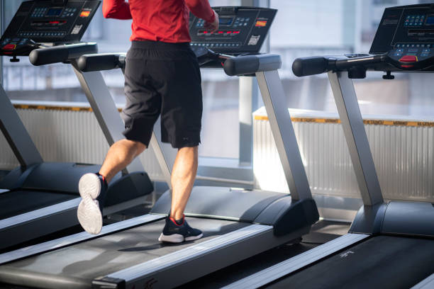 istock unrecognizable young man training at gym, guy runs on treadmill, confident bodybuilder working his body in sport club, bodybuilding concept, legs close up. 1700230825