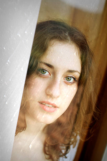 istock Cute girl looking throught window 170023523