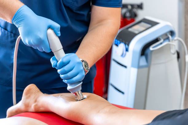 istock Physical therapy of the shin with shock wave, extracorporeal shockwave therapy. 1700237986