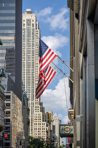 US Flag flying on the background of the facade of the Federal Reserve building in New York