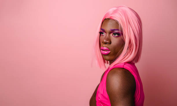 istock Smiling confident black drag queen wearing pink outfit looking at empty space 1700239163