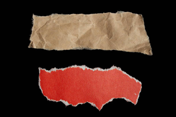 istock Ripped paper piece on isolated black background 1700243092