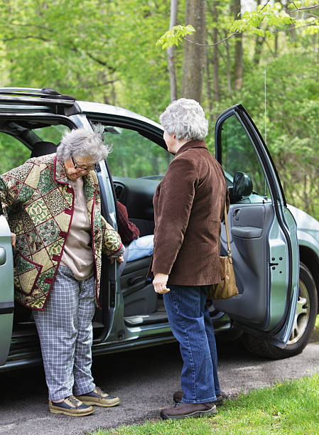 istock Senior Woman Carefully Entering Minivan Car 170024748