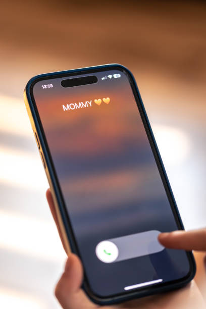 istock Smartphone in child hands with Incoming Mommy call on a screen. 1700247570