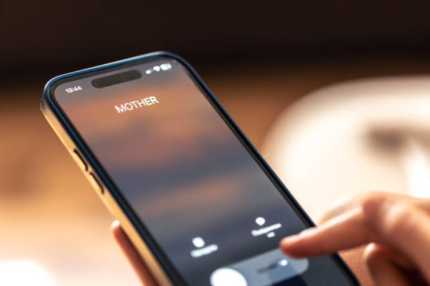 istock Smartphone in child hands with Incoming Mother call on a screen. 1700247576