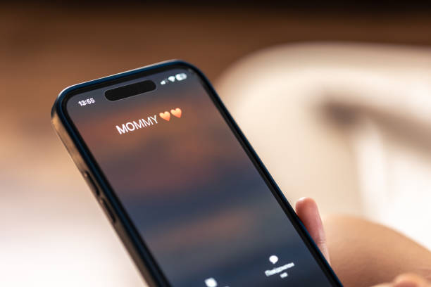 istock Smartphone in child hands with Incoming Mommy call on a screen. 1700247582