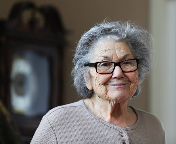 грустно старший женщина улыбаться - grandmother standing senior women senior adult стоковые фото и изображения