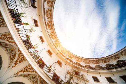 Beautiful oval architecture building in Seville - Spain. Low angle view.