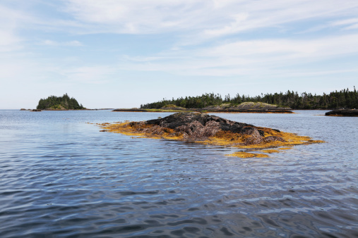 Beautiful, scenic view of inner coastal waters near Mahone Bay, Nova Scotia, Canada. But despite the surface tranquility, this is a dangerous boating passage with no clear channel and many unmarked areas of very shallow water above the jagged, rocky bottom.