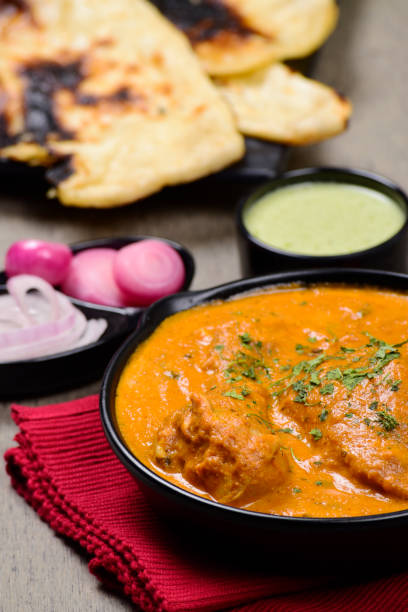 istock Closeup of butter chicken at dinner table 1700258221
