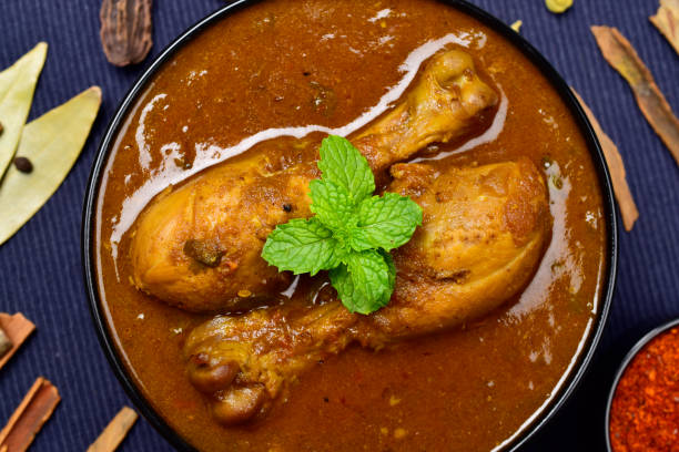 istock Desi chicken masala curry in bowl, chicken leg piece 1700258741