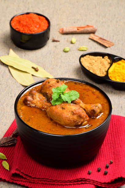 istock Indian style spicy chicken curry in bowl with red chilli and all spices 1700258764