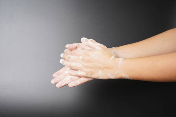 istock Washing hands with hand wash on dark background 1700259327